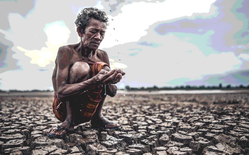 An elderly man sitting in touch with rain in the dry season, glo